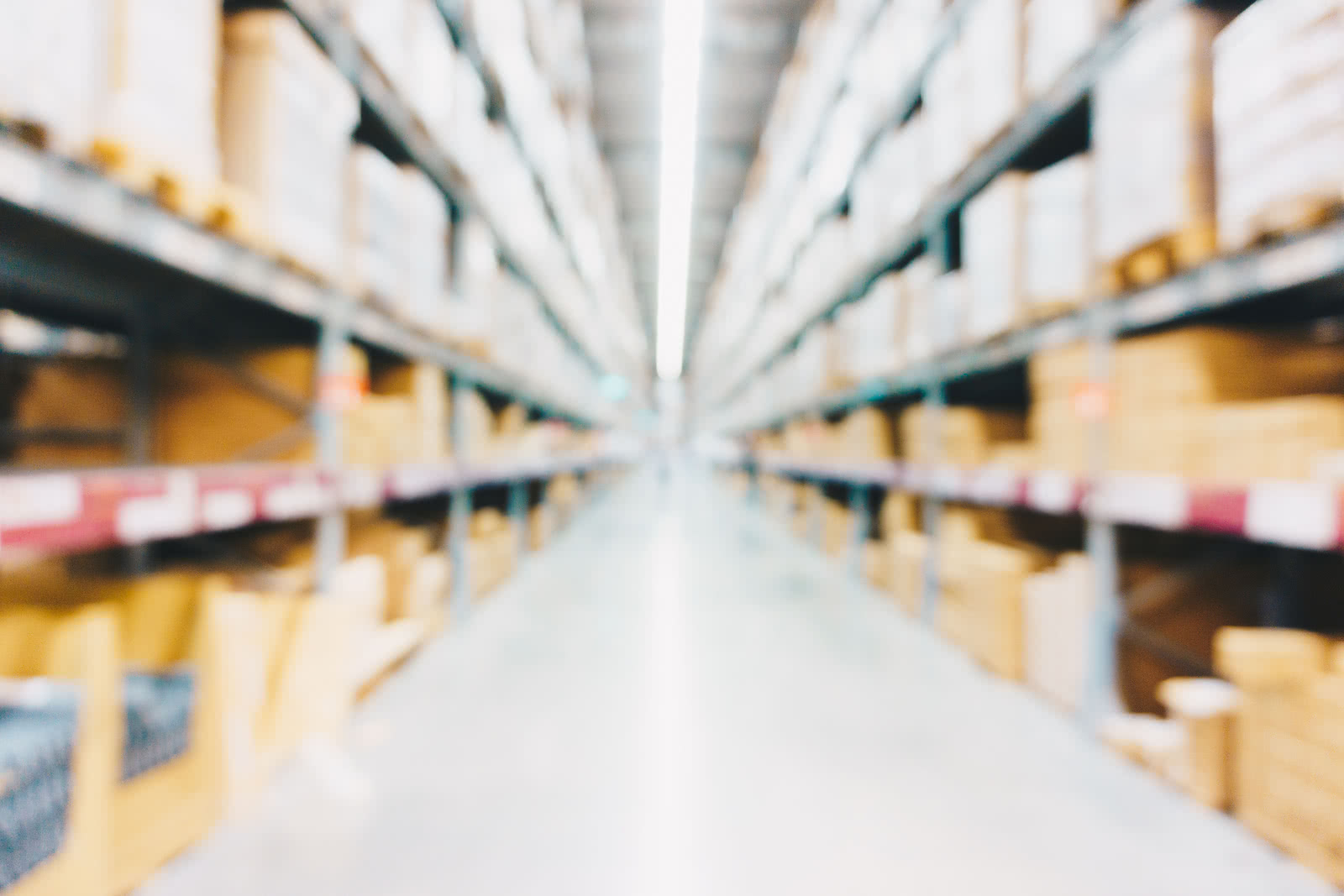 Blurred view of warehouse aisles with stocked shelves
