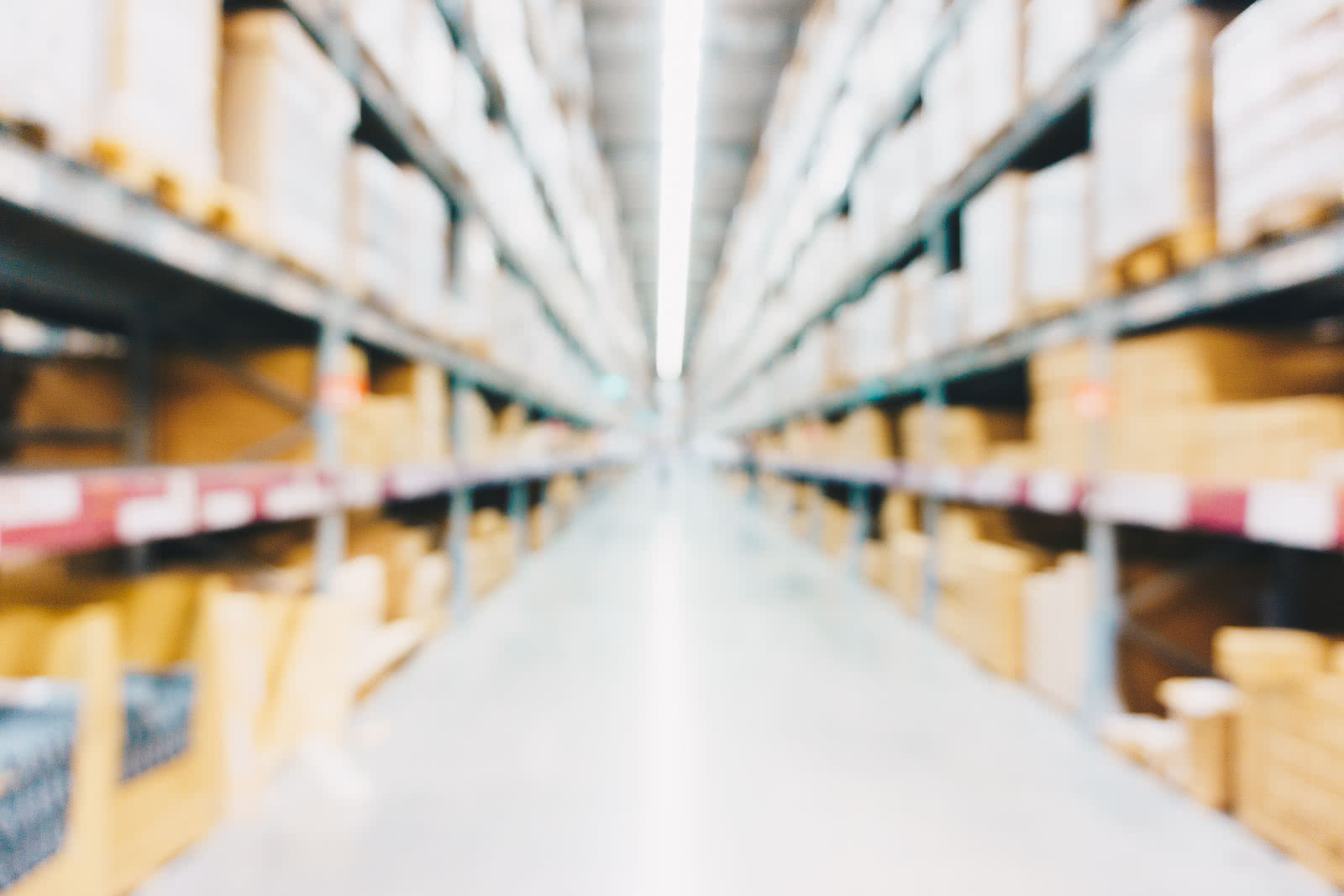 Blurred view of warehouse aisles with stocked shelves