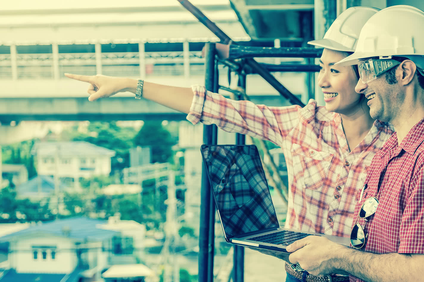 Two construction workers on a build site discussing a working capital loan