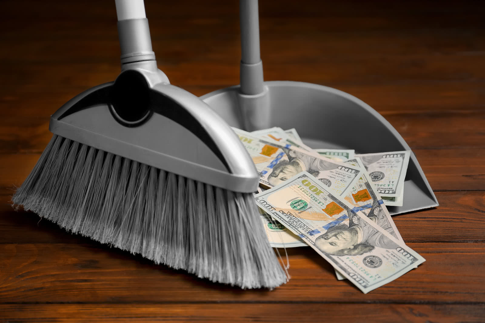 Sweeping dollars into dustpan