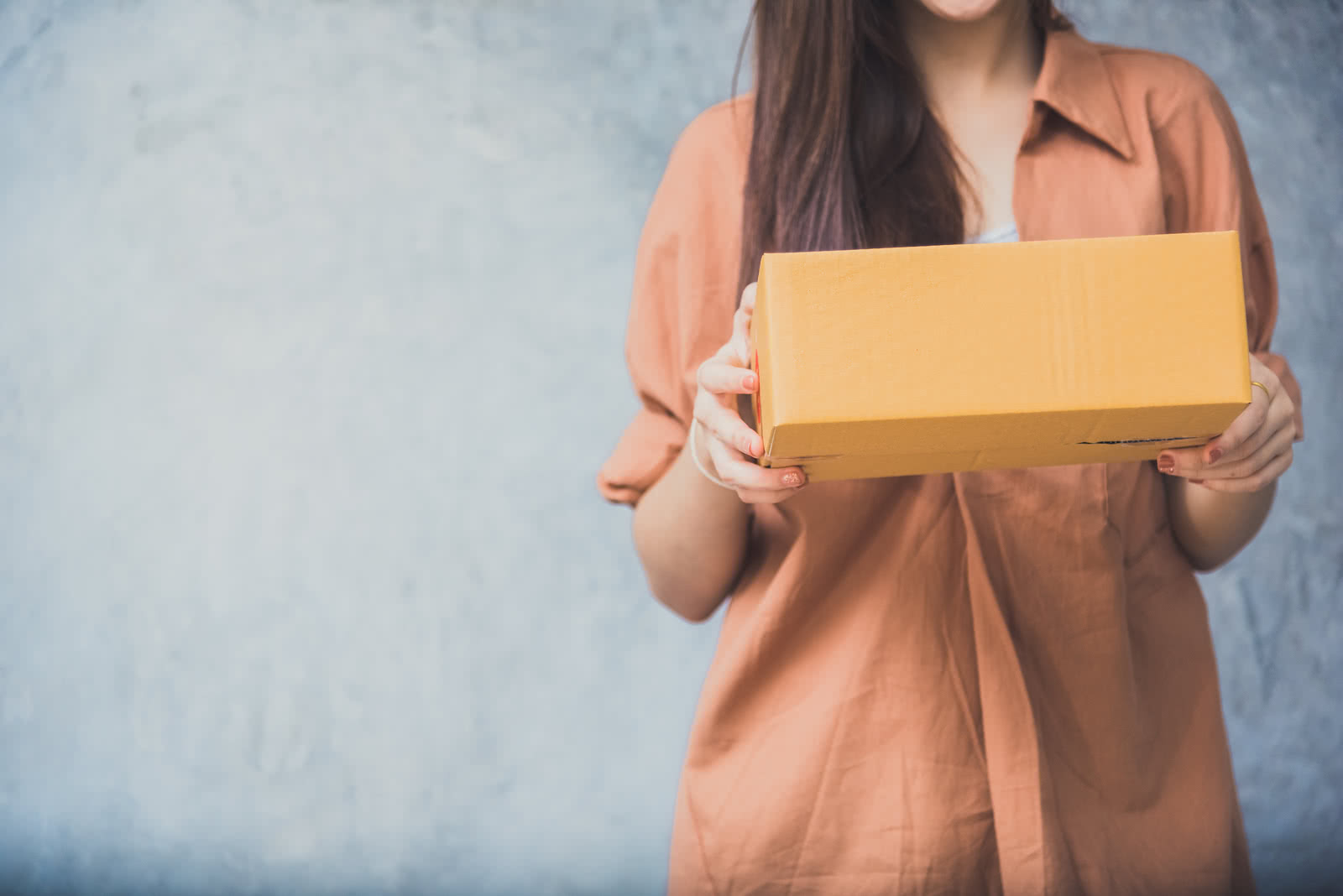 Woman holds a package for customer delivery