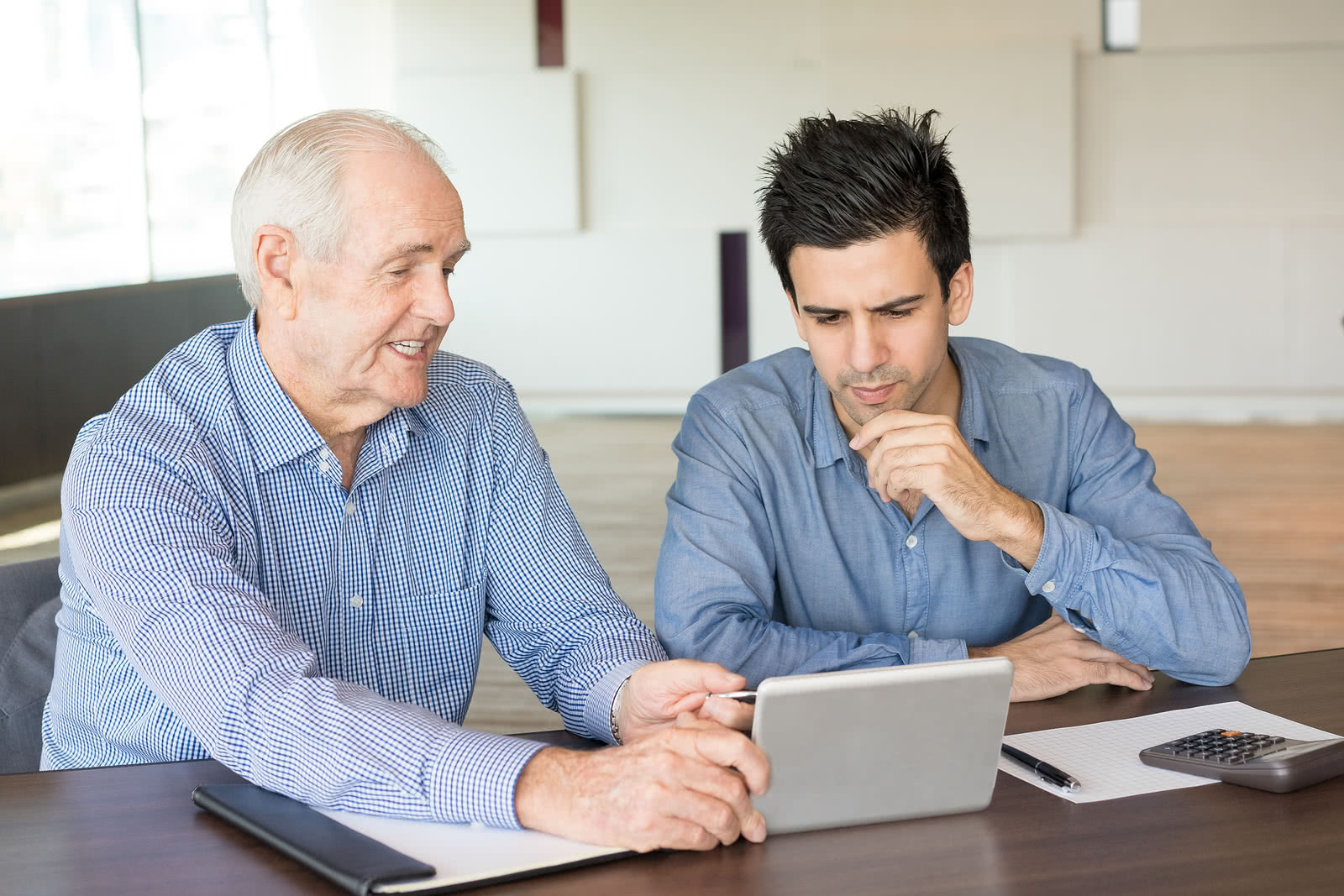 Senior business owner showing younger owner his small business network