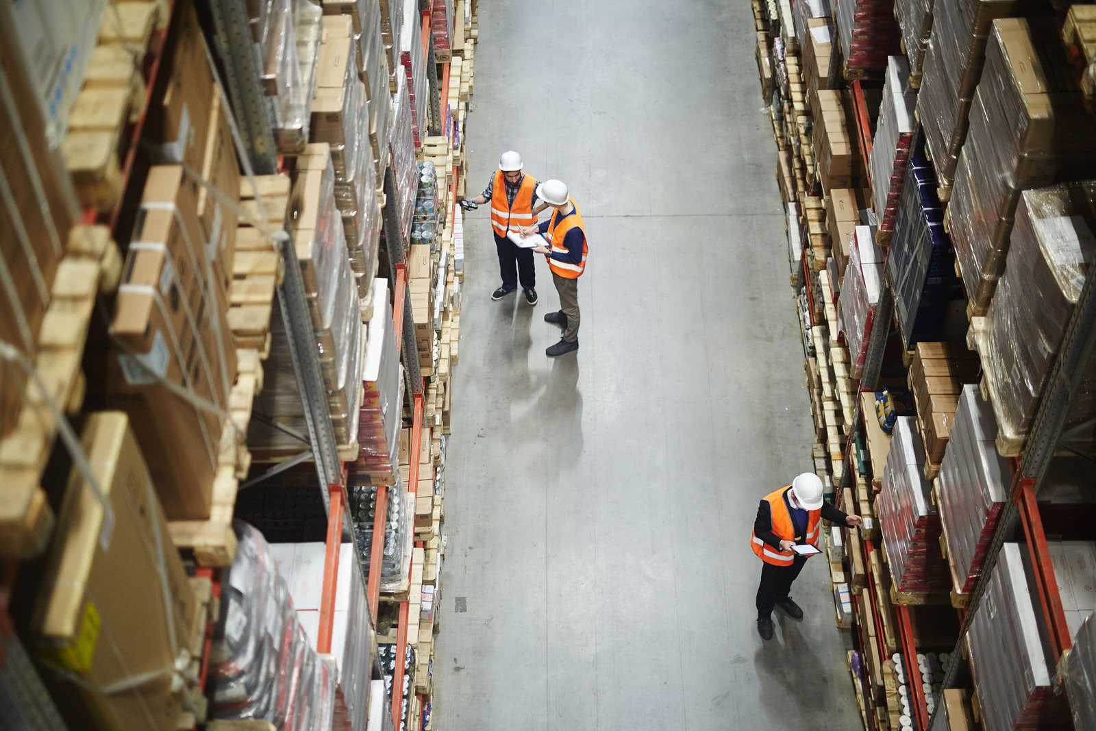 Overhead view of warehouse workers taking stock of their inventory