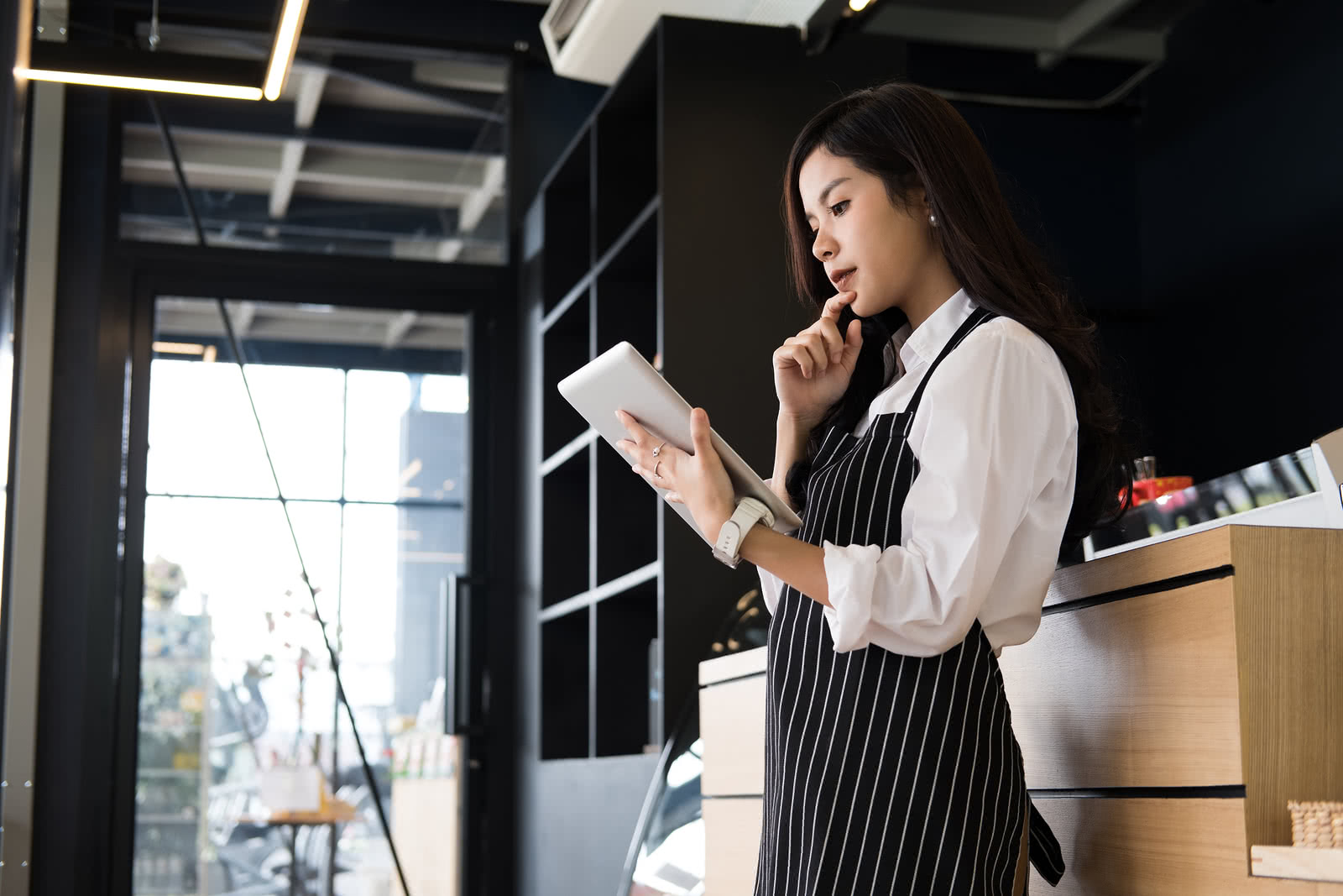 A woman evaluates small business retirement plans on a tablet 