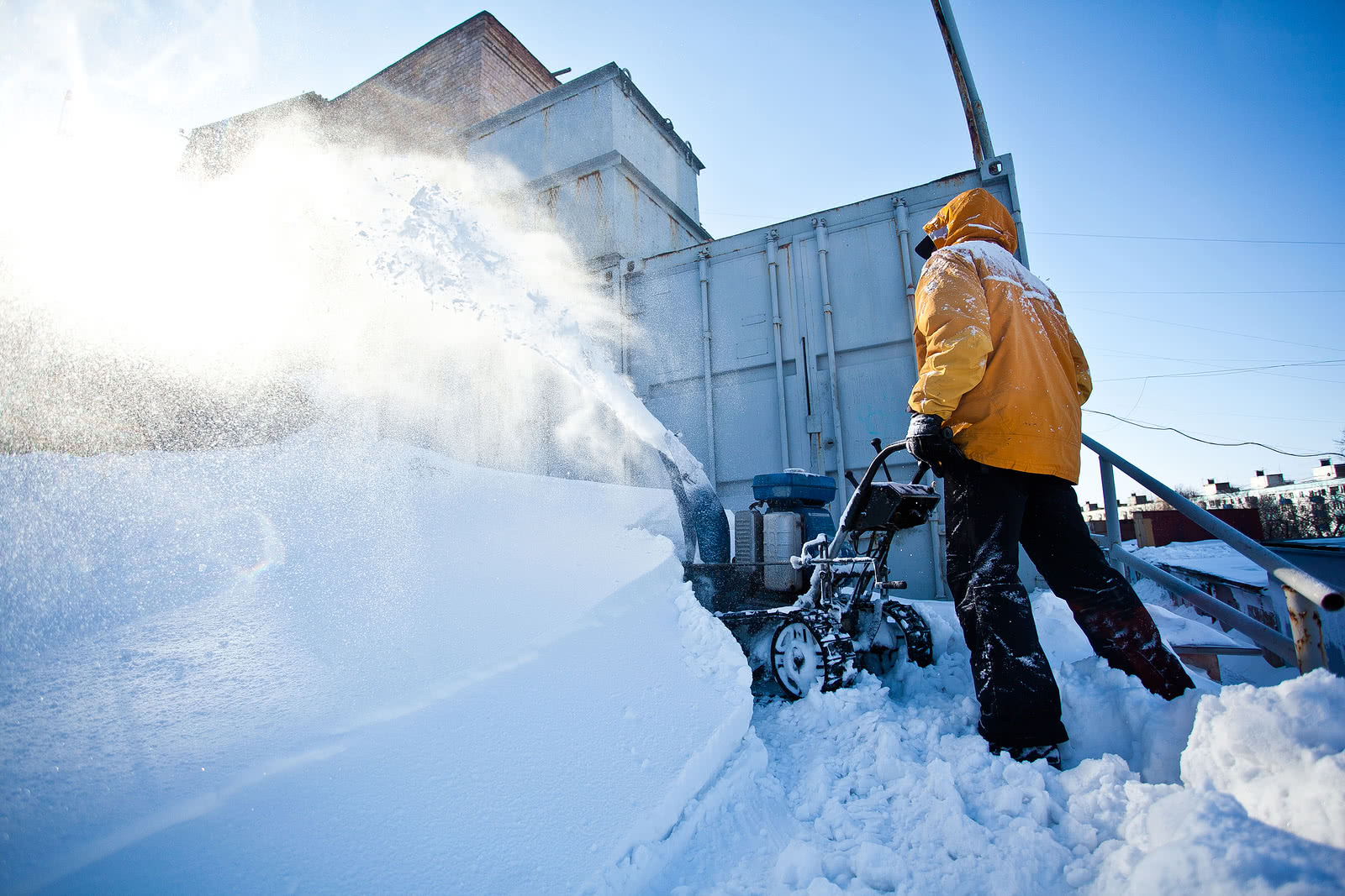 A seasonal worker plows snow for a landscape company