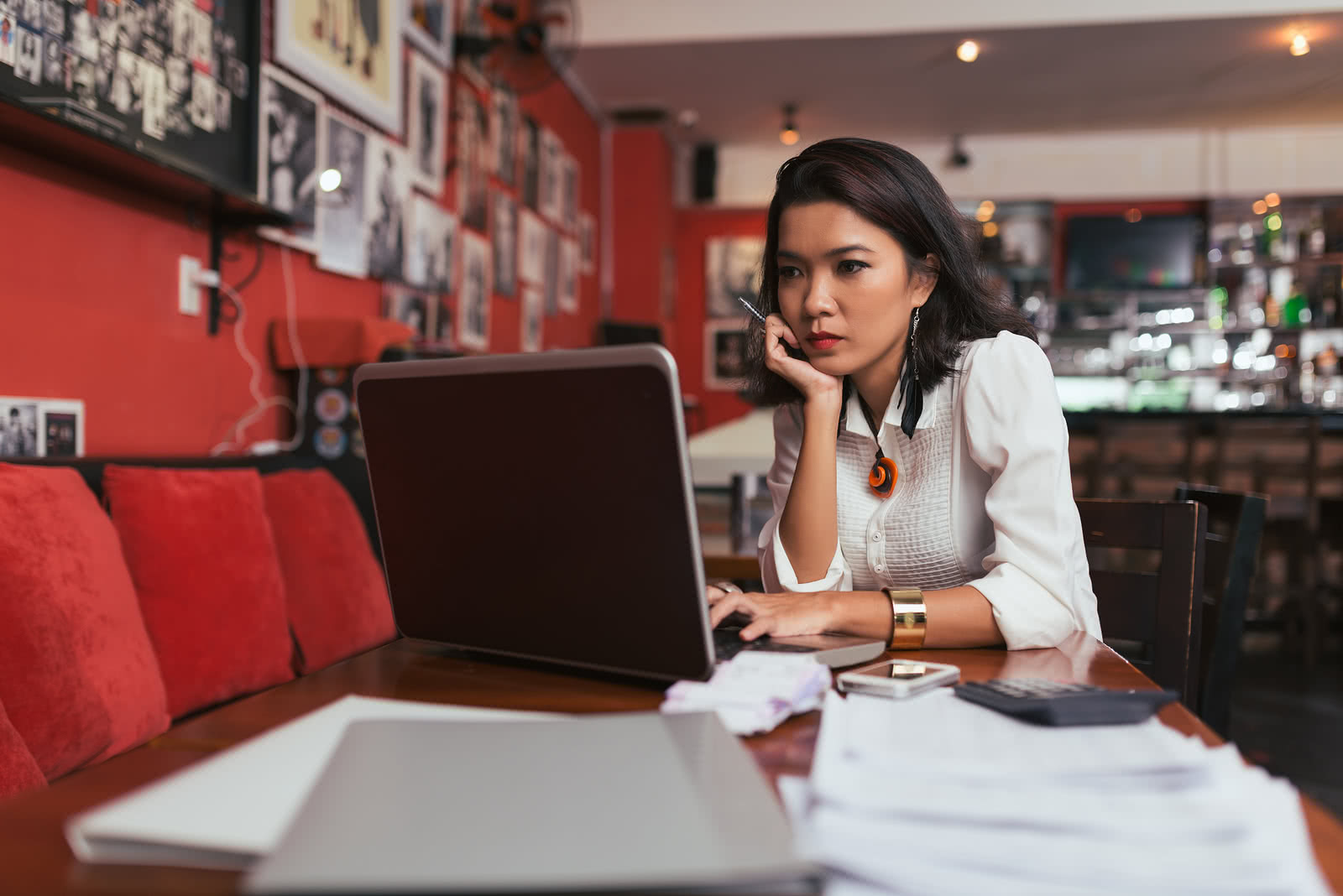 A restaurant owner searches for short-term loans for small business on laptop 