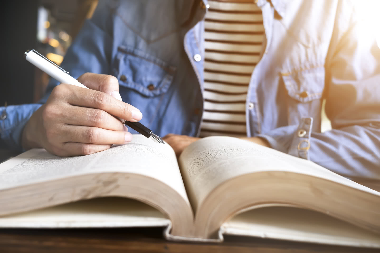 A business owner reviews a book on basic business financial terms 