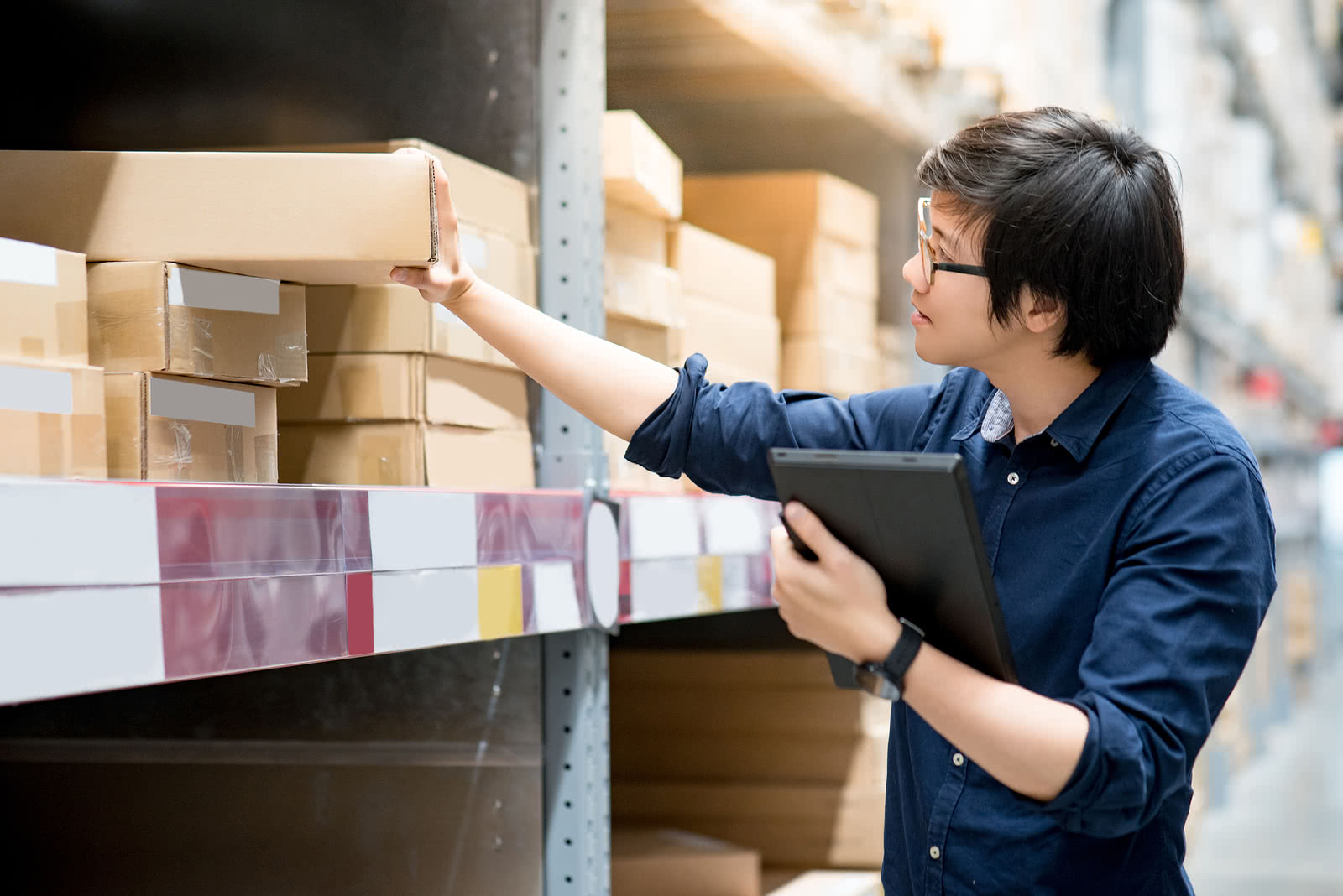 A business owner tracks inventory, a key part of inventory management for small business