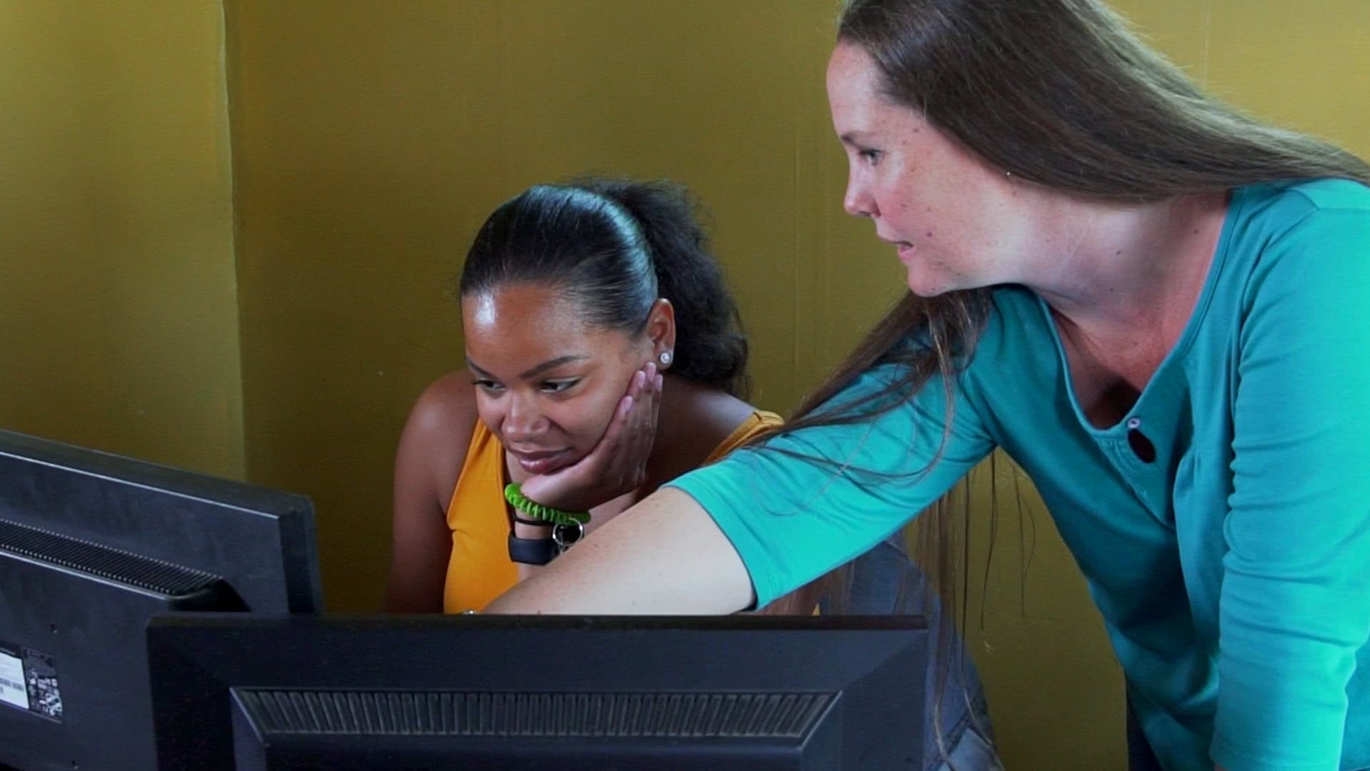 Cheryl Dailey trains an employee on the computer system