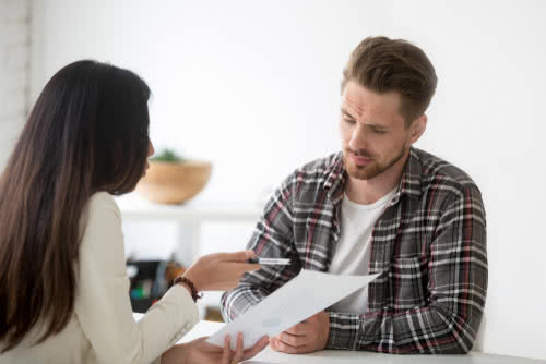 Two business owners review loan paperwork together