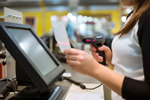 Business owner uses retail POS software to scan bar codes during checkout