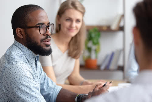 Male business owner tells his colleagues about his insurance company business plan