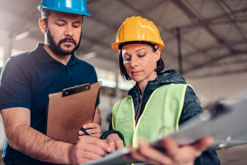 Two construction workers review small business tips and advice