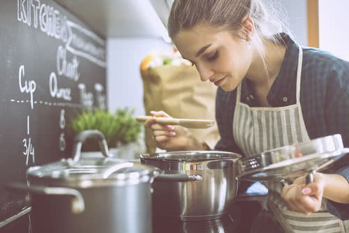 Female chef pays for kitchen equipment with tax deductions for restaurant owners