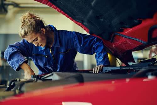 Female mechanic works on Presidents Day, not a paid holiday for small businesses