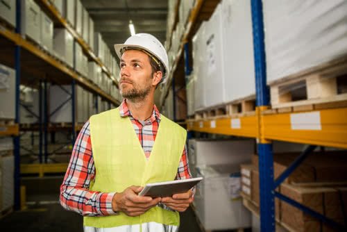 Owner chooses a supplier for his business by touring their inventory warehouse