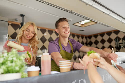 Two food truck owners collect payment with the best finance apps for small business