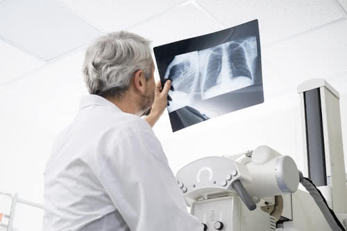 Doctor uses new X-ray machine rented through medical equipment leasing.