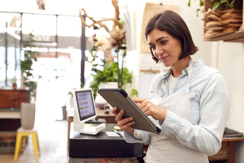 Florist with tablet considers debt vs equity financing