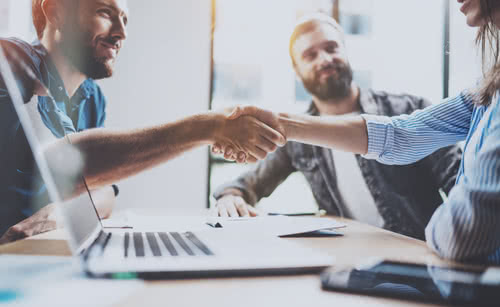 Business partnership handshake concept.Photo two coworkers handshaking process.Successful deal after great meeting.Horizontal, blurred background